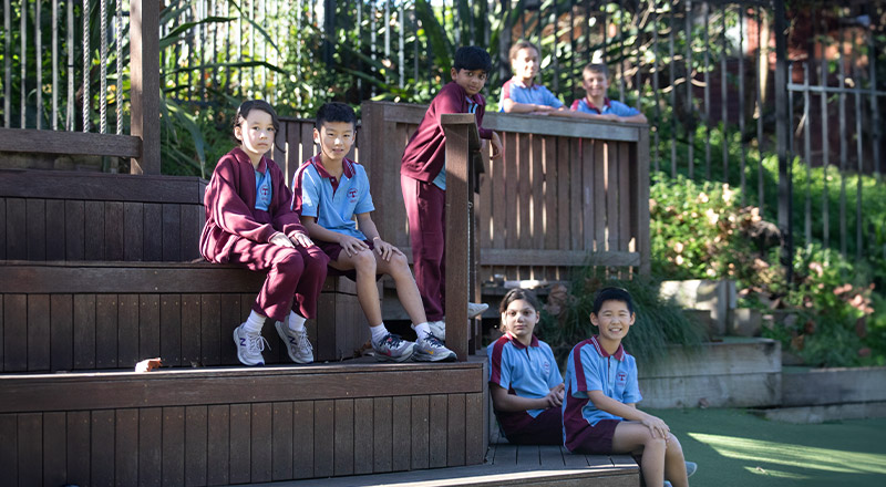 Students sitting together outside in the playground at St Bernadette's Primary School Dundas Valley