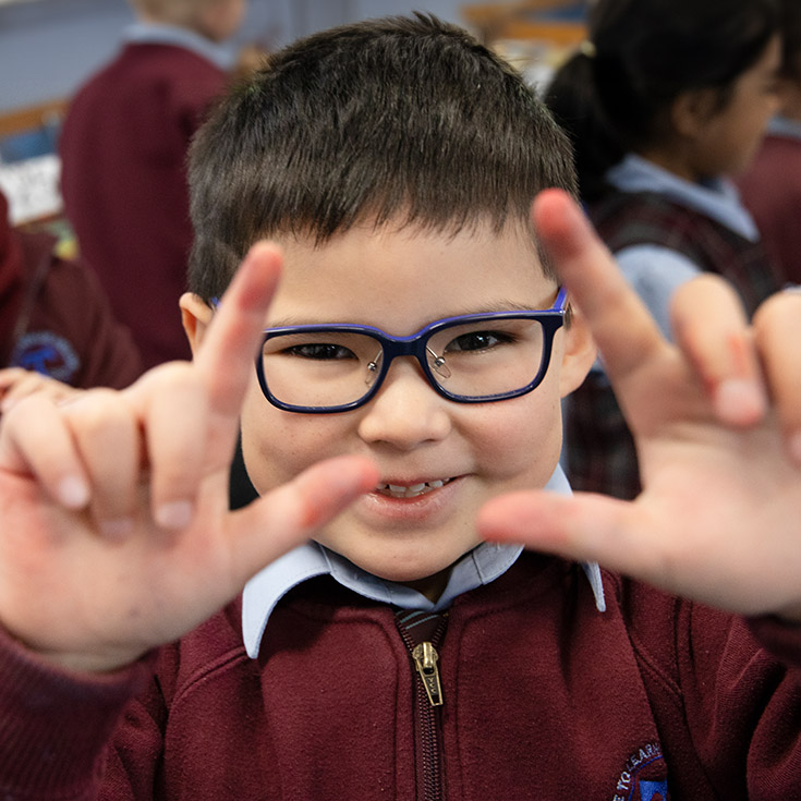 Student smiling in the classroom at St Bernadette's Primary School Dundas Valley