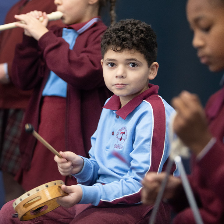 Student playing the tambourine in music class at St Bernadette's Primary School Dundas Valley